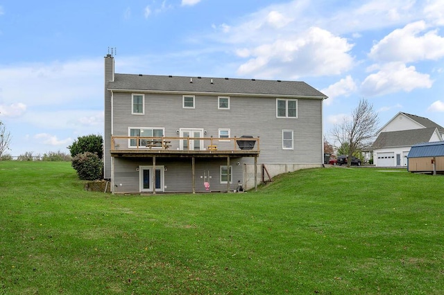 rear view of house with a lawn and a wooden deck