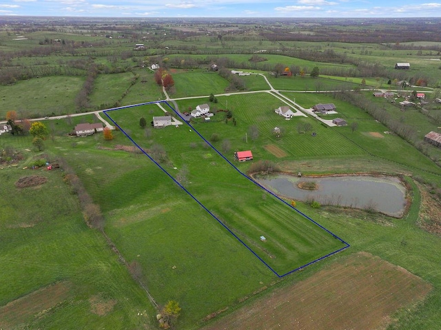 birds eye view of property with a water view and a rural view