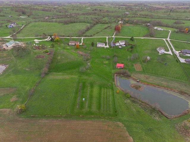 birds eye view of property featuring a water view and a rural view