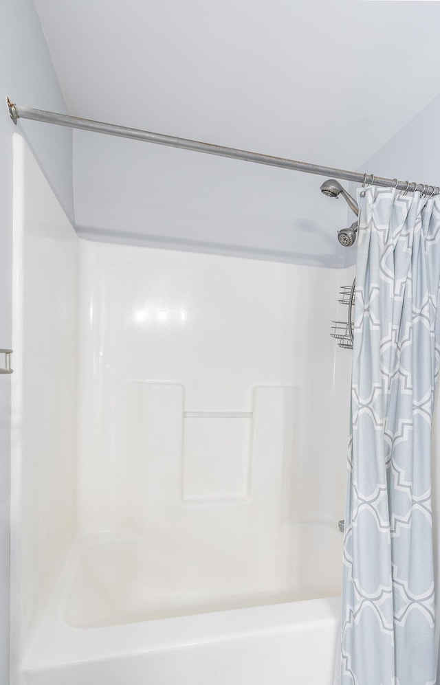 bathroom featuring shower / bathtub combination with curtain