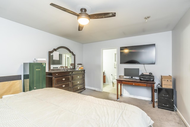 carpeted bedroom featuring ceiling fan and ensuite bath