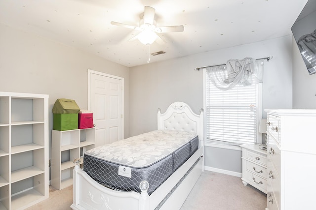 bedroom featuring light carpet and ceiling fan