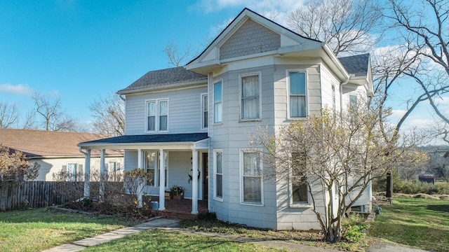 view of front of house with a porch and a front lawn