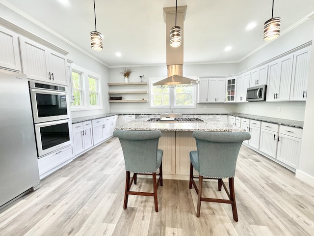 kitchen featuring dark stone countertops, hanging light fixtures, and stainless steel appliances