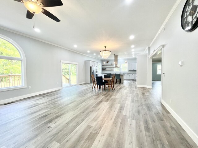 kitchen with dishwasher, a healthy amount of sunlight, white cabinets, and ornamental molding