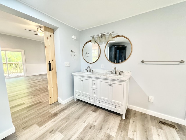 bathroom with ceiling fan, vanity, and wood-type flooring