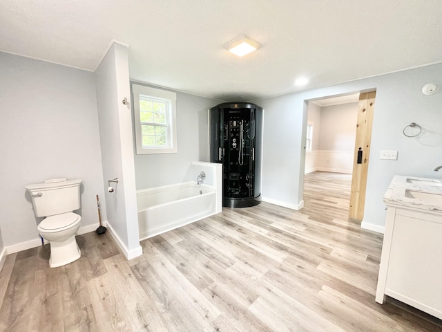 empty room featuring plenty of natural light, a barn door, ornamental molding, and dark hardwood / wood-style floors