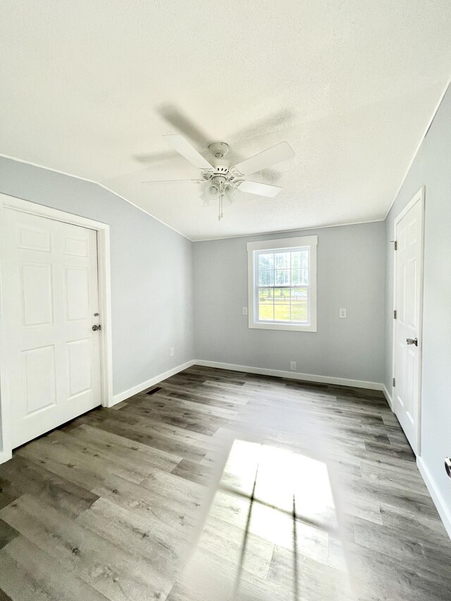 bathroom featuring a textured ceiling, vanity, a bath, and hardwood / wood-style floors