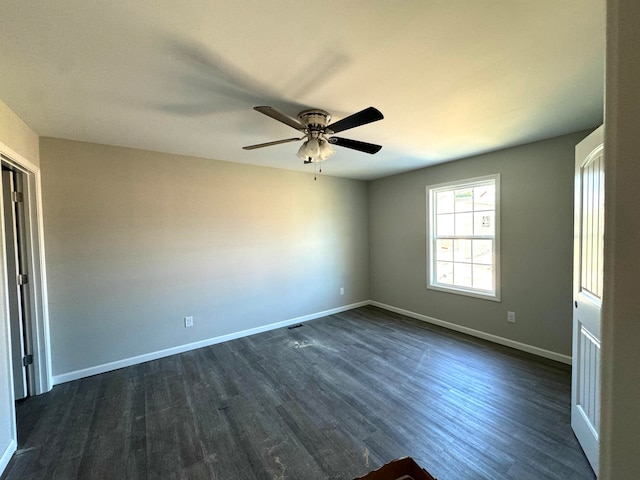 spare room with ceiling fan and dark wood-type flooring