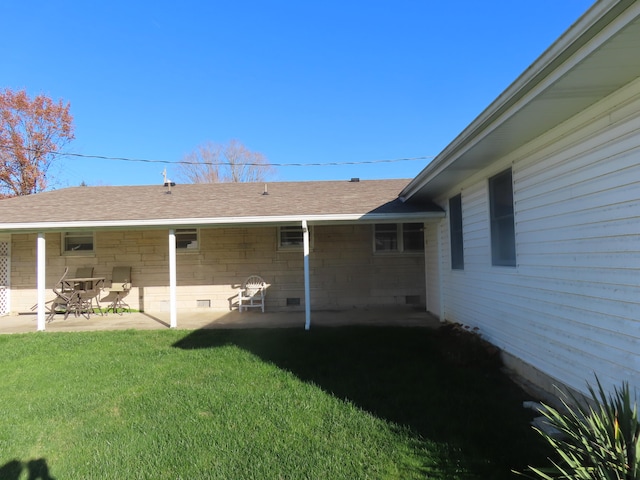 back of property featuring a yard and a patio area