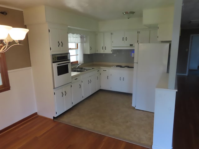 kitchen with white cabinetry, sink, and white appliances