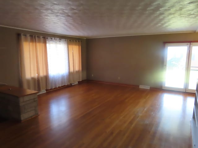 spare room featuring dark hardwood / wood-style floors and ornamental molding