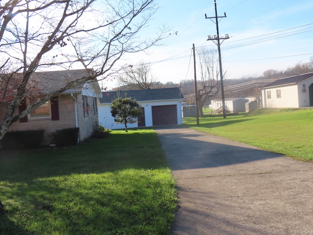 view of front of home with a garage and a front lawn