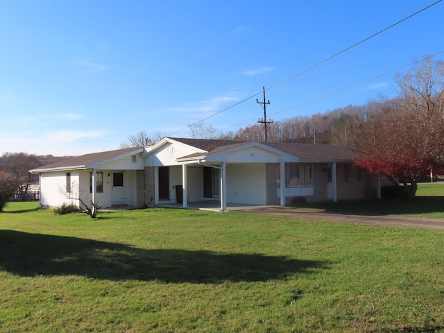 ranch-style house featuring a porch and a front lawn