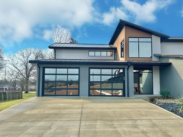 rear view of house featuring a garage