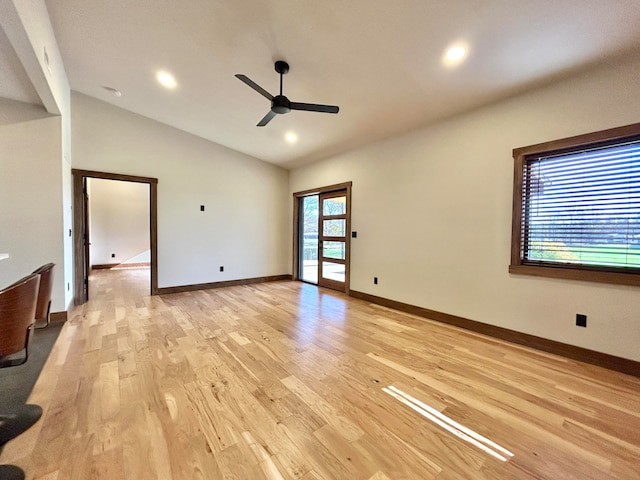 empty room featuring ceiling fan, high vaulted ceiling, and light wood-type flooring