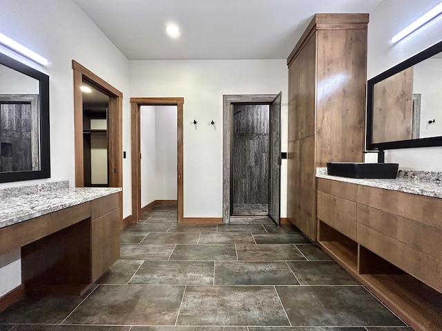 bathroom with vanity and a shower