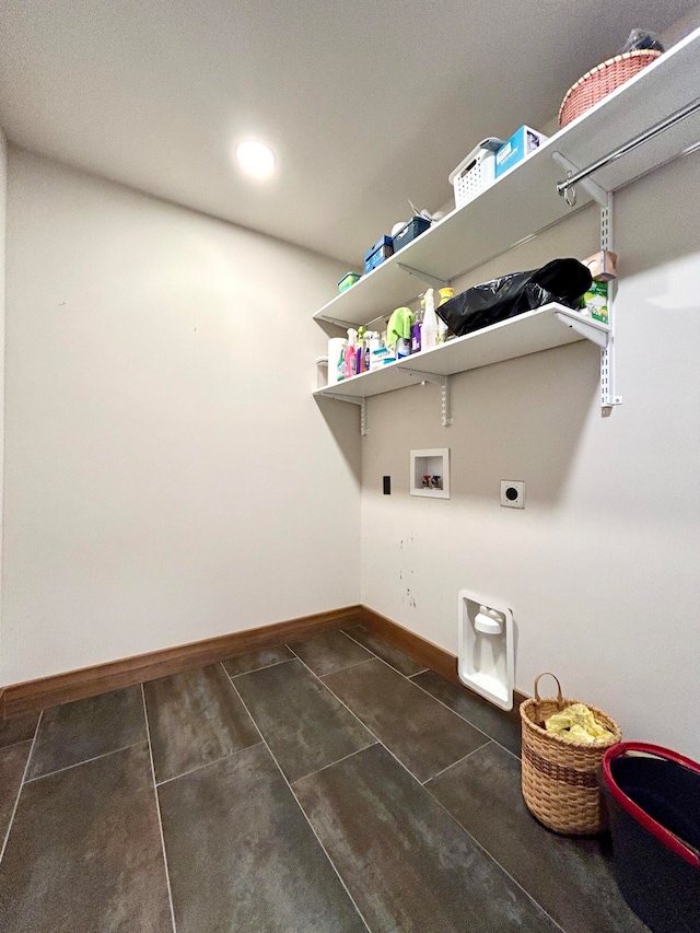 laundry area with hookup for a washing machine, electric dryer hookup, and dark tile patterned flooring