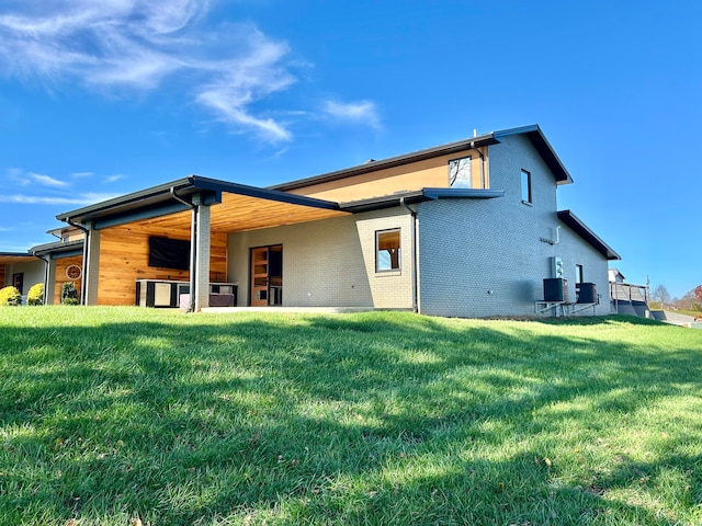 rear view of property featuring a yard