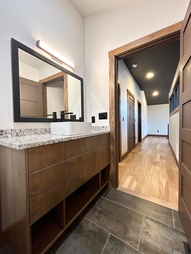 bathroom with vanity and hardwood / wood-style flooring