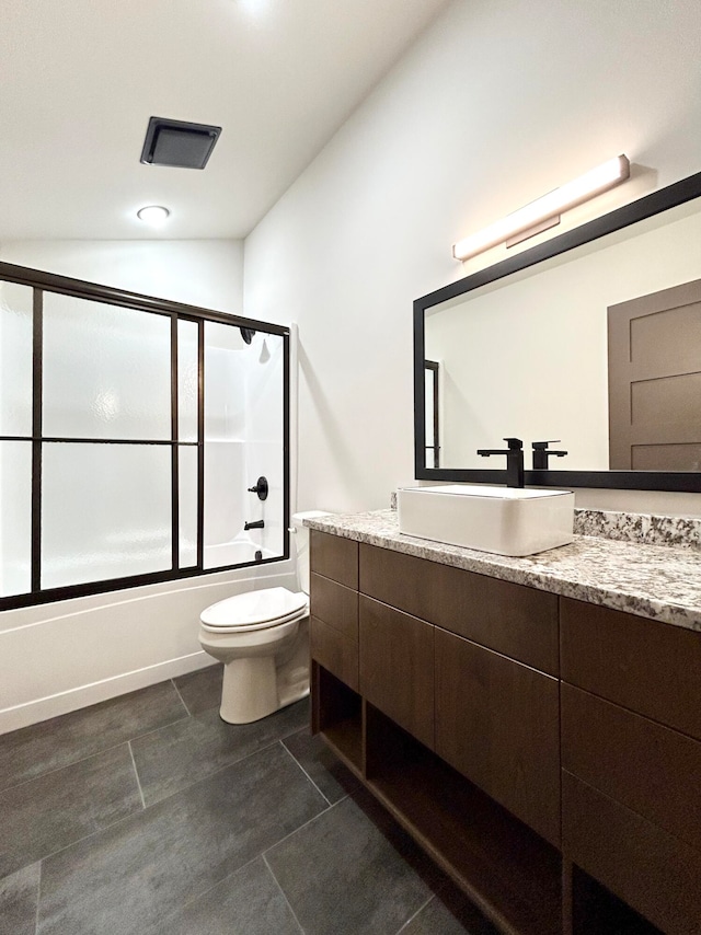 full bathroom with vanity, shower / bath combination with glass door, and toilet