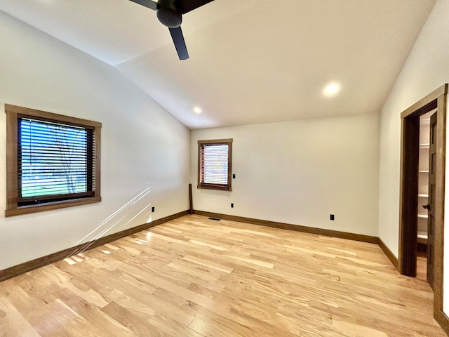 unfurnished room with light hardwood / wood-style flooring, vaulted ceiling, and ceiling fan