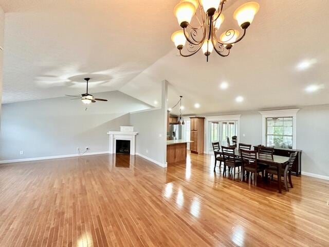 151 Surrounding Hills Dr, Somerset, KY 42503 - living room featuring lofted ceiling, light wood-type flooring, and ceiling fan with notable chandelier