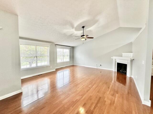 151 Surrounding Hills Dr, Somerset, KY 42503 - unfurnished living room with hardwood / wood-style floors, ceiling fan, a textured ceiling, and vaulted ceiling