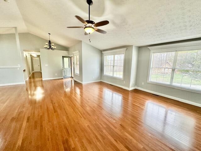 151 Surrounding Hills Dr, Somerset, KY 42503 - unfurnished living room with a textured ceiling, ceiling fan with notable chandelier, hardwood / wood-style flooring, and vaulted ceiling
