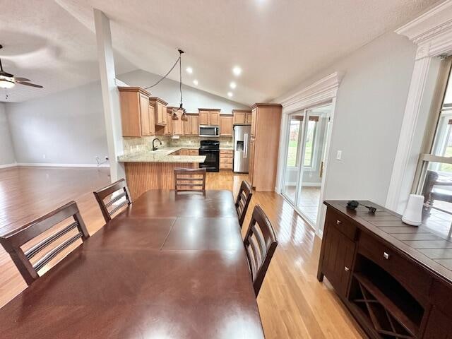 151 Surrounding Hills Dr, Somerset, KY 42503 - dining room with ceiling fan, sink, light hardwood / wood-style flooring, and vaulted ceiling