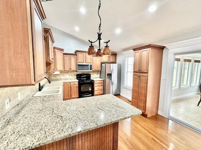 151 Surrounding Hills Dr, Somerset, KY 42503 - kitchen with sink, hanging light fixtures, stainless steel appliances, light hardwood / wood-style flooring, and vaulted ceiling