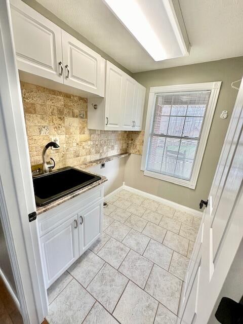 151 Surrounding Hills Dr, Somerset, KY 42503 - laundry area with cabinets, light tile patterned floors, and sink