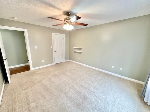 151 Surrounding Hills Dr, Somerset, KY 42503 - unfurnished bedroom featuring ceiling fan, light colored carpet, and a textured ceiling