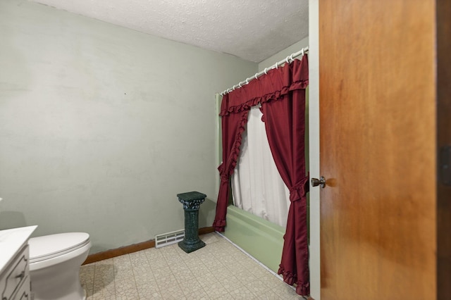 full bathroom featuring vanity, shower / bath combo, a textured ceiling, and toilet