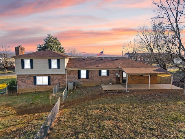 exterior space with central AC, a yard, and a patio