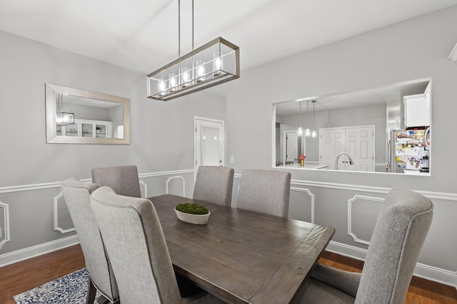 dining room with dark hardwood / wood-style flooring