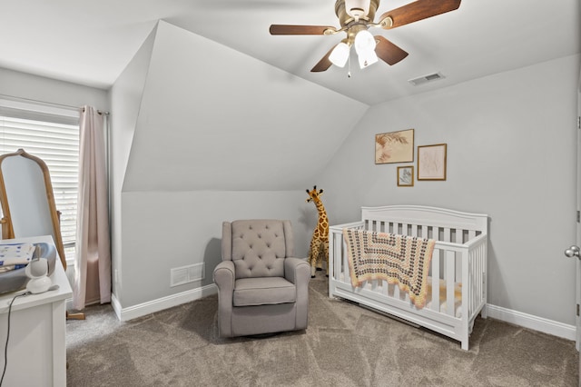 bedroom with carpet flooring, lofted ceiling, ceiling fan, and a crib