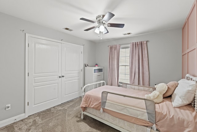 carpeted bedroom featuring ceiling fan and a closet