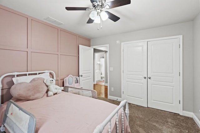 carpeted bedroom featuring ceiling fan and a closet