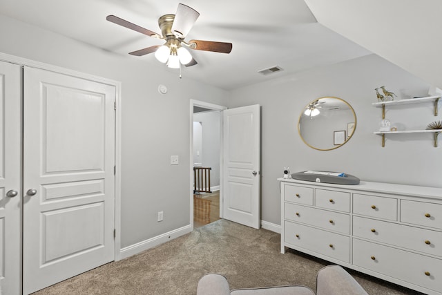 carpeted bedroom featuring a closet and ceiling fan