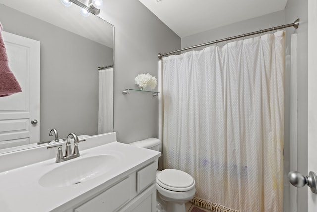 bathroom with vanity, toilet, and walk in shower