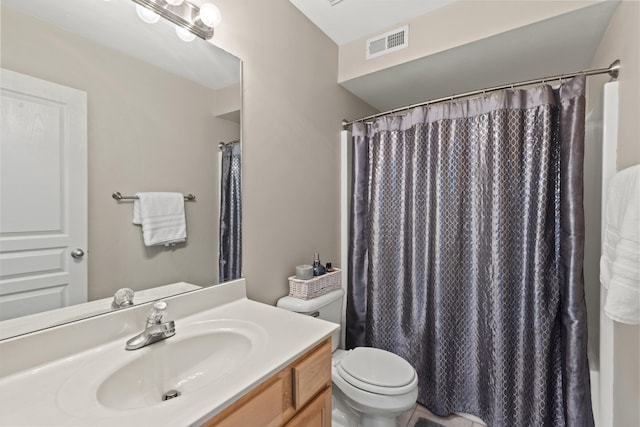 bathroom featuring vanity, a shower with shower curtain, and toilet