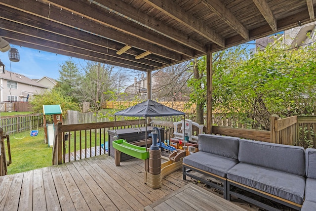 wooden terrace featuring a playground, outdoor lounge area, and a lawn