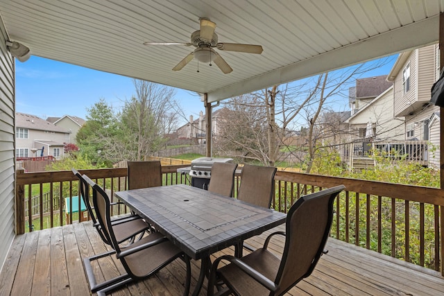 wooden terrace featuring ceiling fan and area for grilling