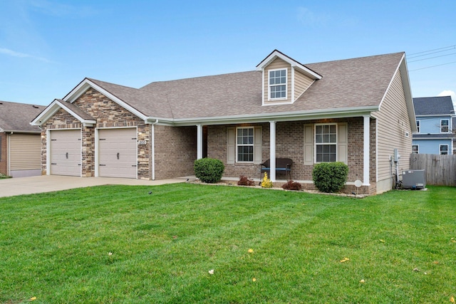 view of front of house featuring a front yard, a garage, and central air condition unit