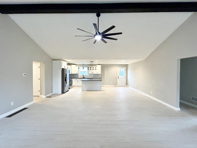 unfurnished living room with light wood finished floors, baseboards, a ceiling fan, vaulted ceiling with beams, and recessed lighting