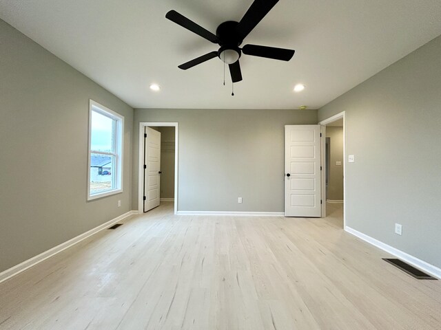 full bathroom featuring double vanity, wood finished floors, a sink, and baseboards