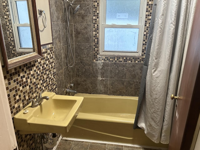 bathroom with tile patterned floors, sink, tile walls, and shower / tub combo with curtain