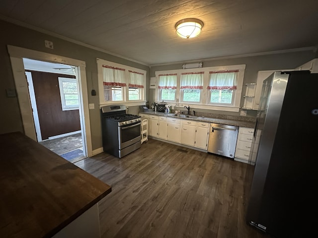 kitchen with a wealth of natural light, white cabinetry, dark hardwood / wood-style flooring, and stainless steel appliances