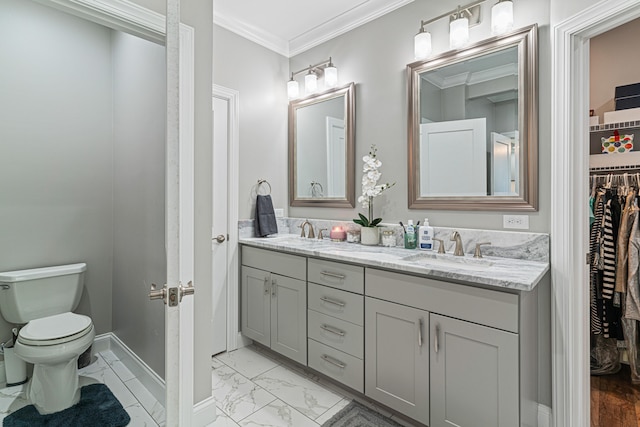 bathroom featuring vanity, toilet, and ornamental molding